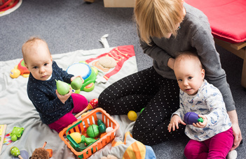How do babies familiarize themselves with the social world?